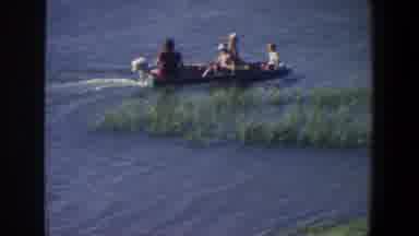 Saint Paul Minnesota (1971): People On A Small Boat Near Grasses In The Water
