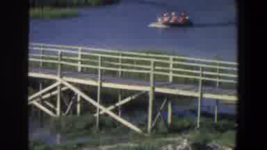 Saint Paul Minnesota (1971): Small Motorboat Sailing Through A Swamp Near A Bridge