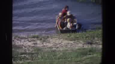 Saint Paul Minnesota (1971): Four People Sitting In Grey Rowboat On A Clear Day