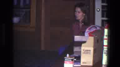 Saint Paul Minnesota (1971): Woman Wearing Red Plaid Shirt Sits Near Brown Door