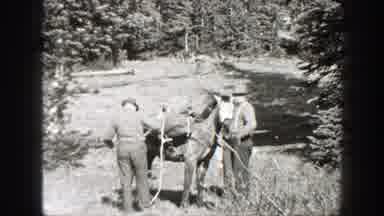 California (1938): Two Men Prepare Horse With Supplies To Go Horseback Riding