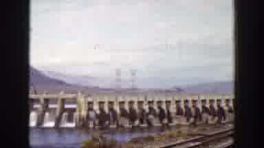 California (1938): Bridge And Telephone Poles By The Waterside By The Mountains