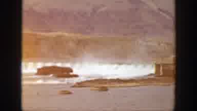 California (1938): View Of Dam Releasing Water And Men Loading Horses On A Clear