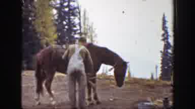 California (1938): Men Loading A Pack Horse In The Woods