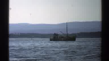 Norway (1976): A Ship Sailing Across The Sea With A Boat Following