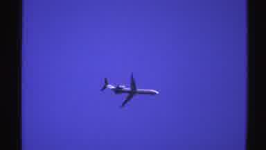 Norway (1976): White Jet Plane Flying In Blue Sky On A Clear Sunny Day