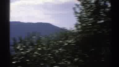 Norway (1976): Scenery Shot From Moving Vehicle Includes Trees Sky Mountains