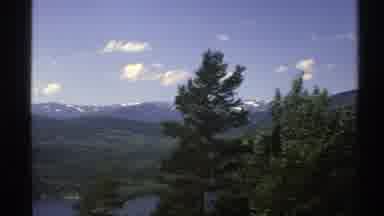Norway (1976): Footage Passing By A Massive Lake With Snowy Mountains In The