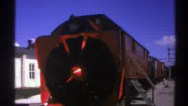 Norway (1976): A Red Light In The Foreground With Red Train In The Background