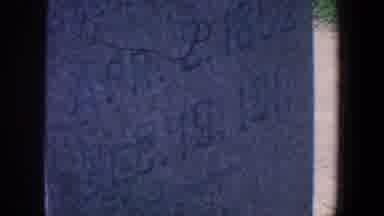 Iowa (1959): Camera Focuses On Small Building In A Graveyard And Pans To An
