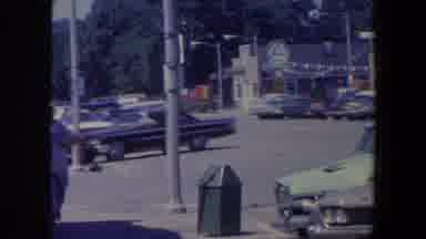 Iowa (1959): Cars Are Parked On The Street Of A Town As A Man Walks Down The