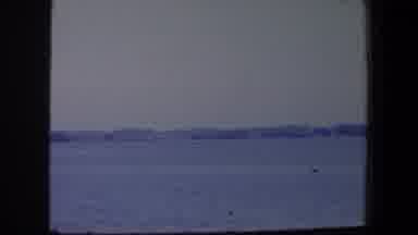 Iowa (1959): Sign Across A Calm Body Of Water With Land And Trees On The Other