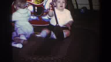 Saint Paul Minnesota (1973): Two Toddlers Play With A Toy Guitar And A Rocking