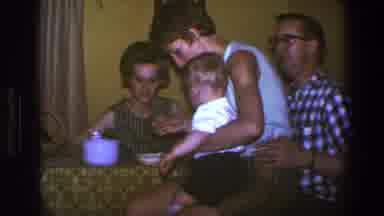 Saint Paul Minnesota (1973): Trying To Feed The Baby While Relatives Look On