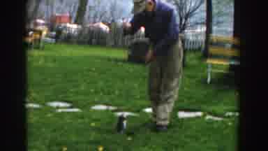 Novi Michigan (1961): Older Gentleman Holding A Catfish With A String On A Green