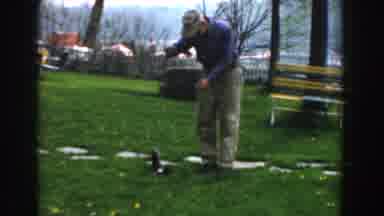 Novi Michigan (1961): Man Playing With Fish On Grass