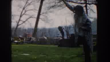 Novi Michigan (1961): Person Wrapped In Gray And White Blanket Holds Up Fish From
