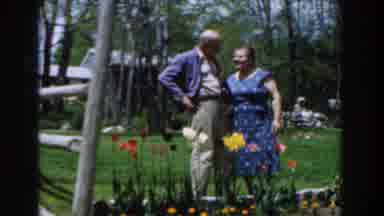 Novi Michigan (1961): A Couple Is Standing In Front Of Their Flowers Enjoying The