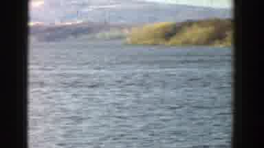 Wisconsin-1957: People Paddling Canoes And Kayaks In A Large Open Lake