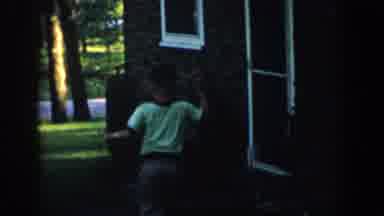 Wisconsin (1957): Boy Playing In Yard During The Summertime On The Front Steps Of