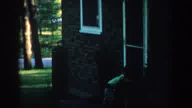 Wisconsin (1957): A Boy Playing With A Dog By A House And In A Yard