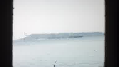 Wisconsin (1957): Camera Pans Across A Water Landscape With Mountains In The