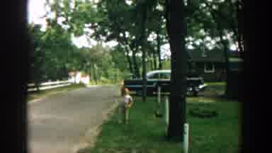 Wisconsin (1957): Happy Child Greets After Returning Home From School On A Sunny