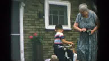 Wisconsin (1957): Grandmother Playing With Three Young Children With A Clock And A