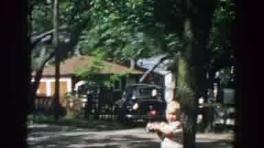 Wisconsin (1957): An Infant Being Shown By A Young Male Child How To Play With A