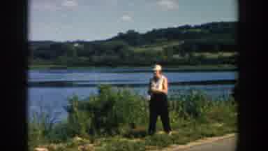 Wisconsin (1957): A Woman Walking On The Grass Holding Fishing Rod A Boy Walking