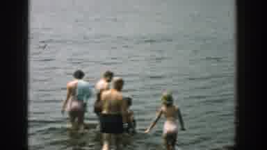 Wisconsin (1957): Two Women And A Man Accompanied By Children Wade Into A Lake