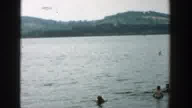 Wisconsin (1957): People In Swimsuits Frolicking In The Water At The Lake On A