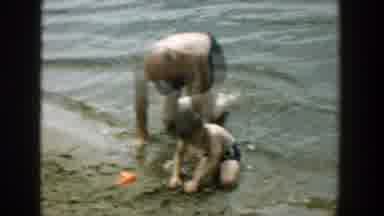 Wisconsin (1957): A Family At The Beach Playing In The Water Making Sand Castles