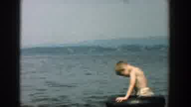 Wisconsin (1957): Children Float And And Play With Small Black Inner Tubes In A