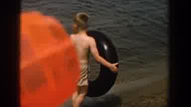 Wisconsin (1957): Blonde Boy With Tire In The Water During The Day