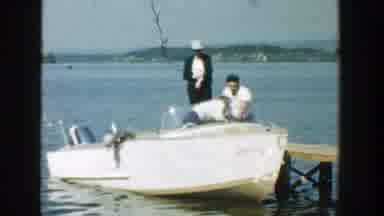 Wisconsin (1957): Person Wearing White Shirt Gets Out Of White Boat On A Sunny Day