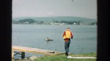 Wisconsin (1957): Man Walking On Bridge By The Sea Going Towards People In A Boat