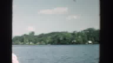 Wisconsin (1957): Panning Shot Showing Boat Ride Through Dark Blue Water Amongst
