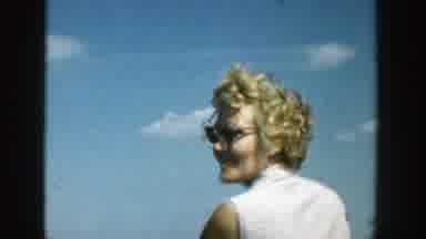 Wisconsin (1957): Couple Standing Outdoors On A Sunny Day With A Few Clouds In The