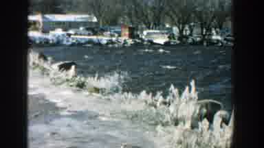 Wisconsin (1957): View Of Blue River Waves Splashing Against Shore And Person