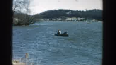 Wisconsin (1957): View Of Grey Wooden Bridge And People In Small Motorboat On A