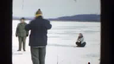 Wisconsin (1957): People Wearing Winter Clothing Playing On A Frozen Lake With
