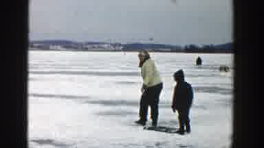 Wisconsin (1957): A Parent And Their Child Walking On A Snowy Stretch Of Land In