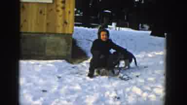 Wisconsin (1957): A Dog And Its Owner Having Fun At A Snowy Mountain