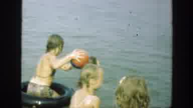 Connecticut (1947): Kids Splash In Lake Water While Couple Sits On Green Object