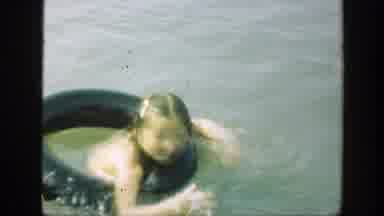 Connecticut (1947): Boy Wearing Red Shorts Stands In Lake Water On A Clear Day
