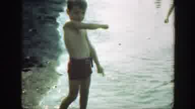 Connecticut (1947): Boy Wearing Red Shorts Walks Toward Camera On A Sunny Day