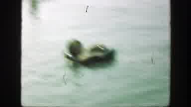 Connecticut (1947): Girls Floats In Water Using Black Inner Tube On A Clear Day