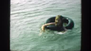 Connecticut (1947): Girl Playing And Smiling For A Camera Inside A Float On A Lake