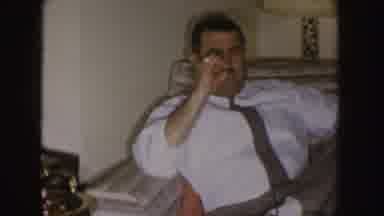 Nebraska (1955): A Man Dressed In A White Shirt Sits On Furniture And Smokes A